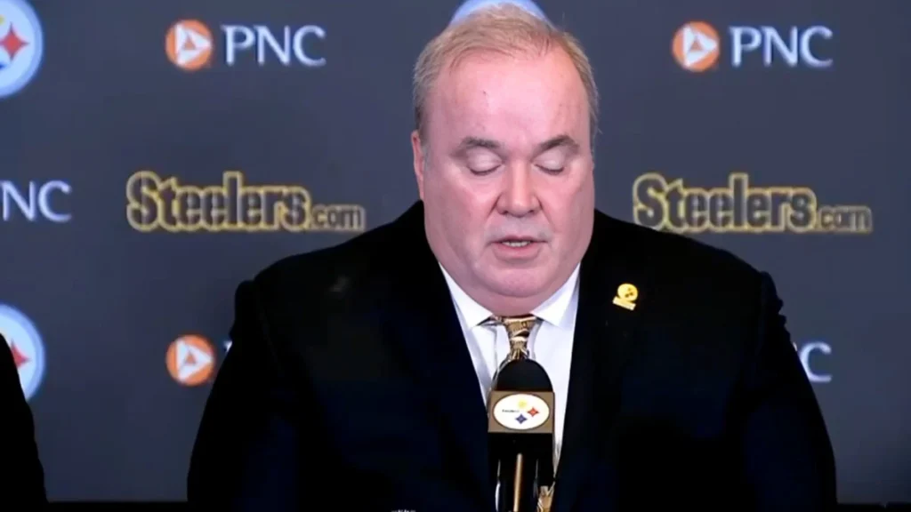 Mike McCarthy during his introductory press conference as the Pittsburgh Steelers head coach, standing in front of a backdrop featuring Steelers and PNC logos.